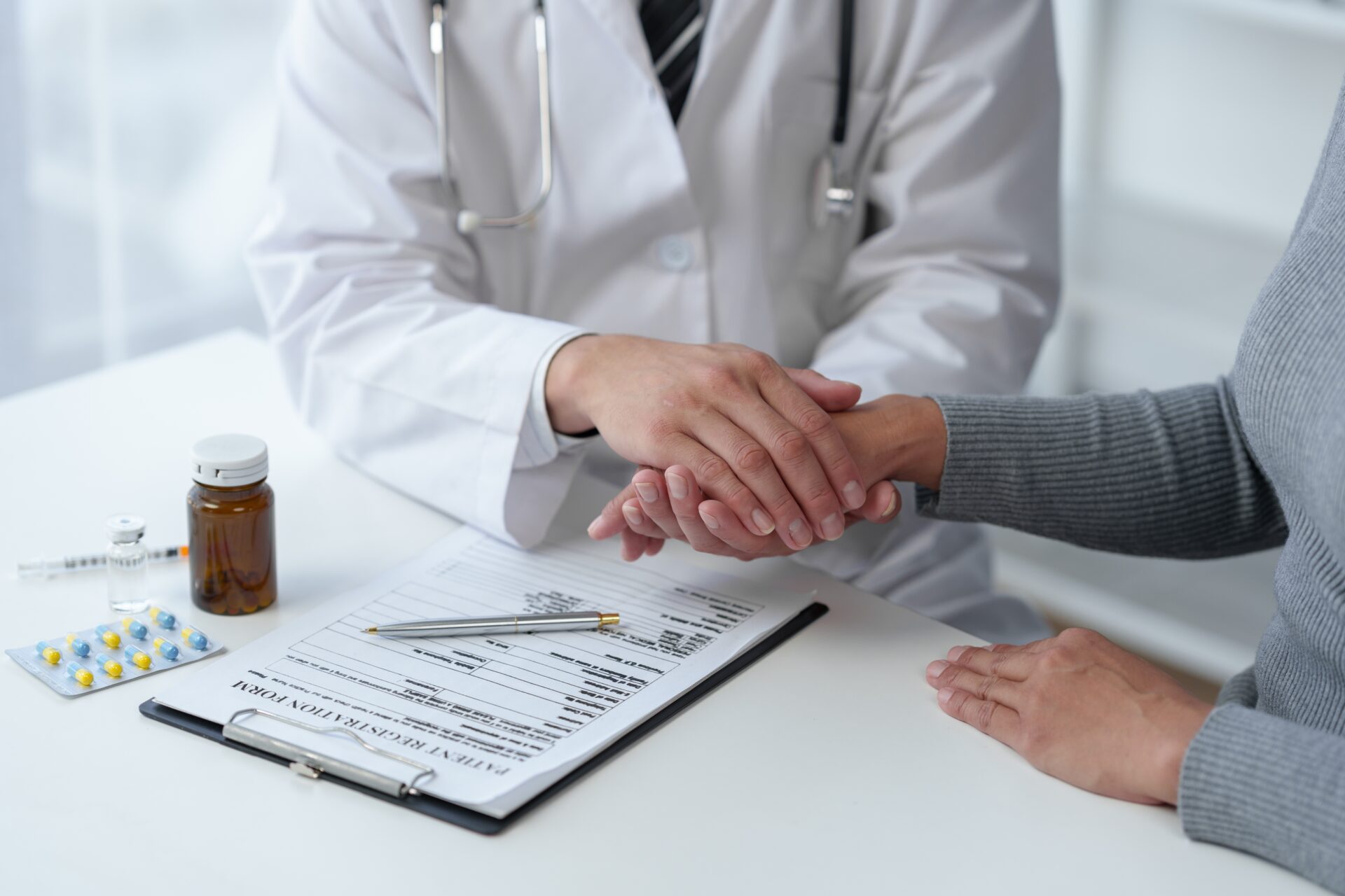 pharmacist comforting patient in consultation room to recieve treatment for common consition