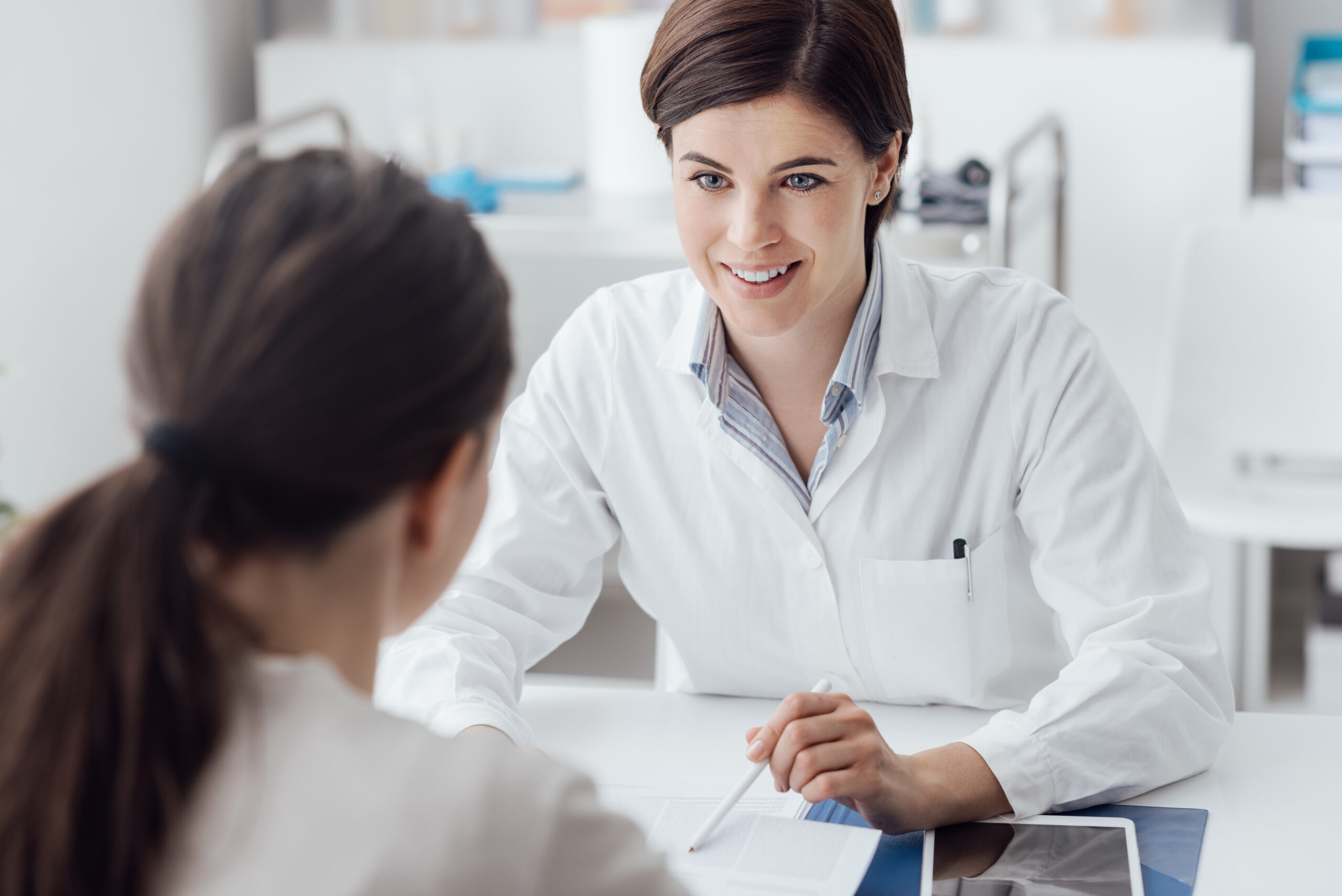 pharmacist giving patient a clinical consultation on weight management in the consultation room in pharmacy